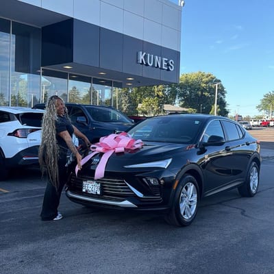 Customer celebrating with her new car